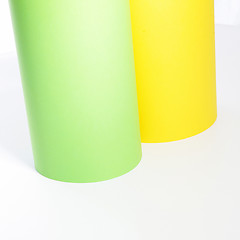 Image showing Green and yellow rolls of cardboard