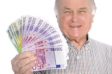 Image showing Smiling senior man with a fistful of money