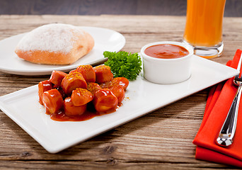 Image showing curry wurst spicy sausage with curry and ketchup