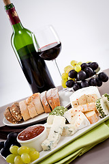 Image showing cheese plate with grapes and wine dinner