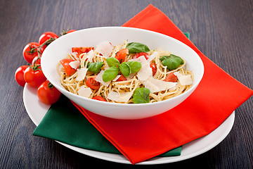 Image showing fresh tasty pasta spaghetti with tomatoes and basil