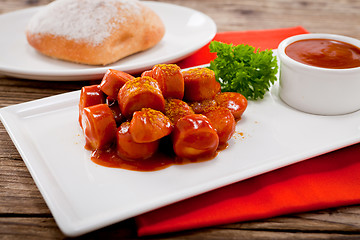 Image showing curry wurst spicy sausage with curry and ketchup