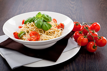 Image showing fresh tasty pasta spaghetti with tomatoes and basil