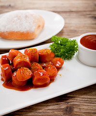 Image showing curry wurst spicy sausage with curry and ketchup