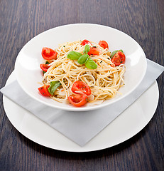 Image showing fresh tasty pasta spaghetti with tomatoes and basil