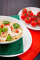 Image showing fresh tasty pasta spaghetti with tomatoes and basil