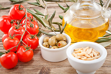 Image showing tatsty geen olives tomatoes and olive oil 