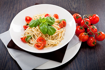 Image showing fresh tasty pasta spaghetti with tomatoes and basil