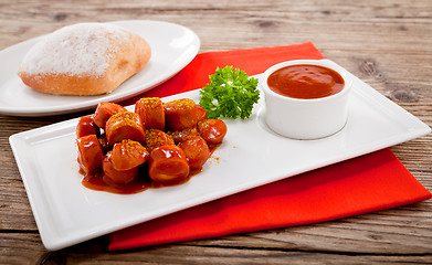 Image showing curry wurst spicy sausage with curry and ketchup