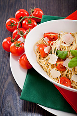 Image showing fresh tasty pasta spaghetti with tomatoes and basil