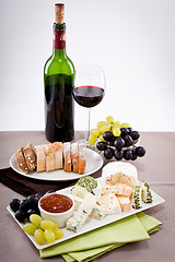 Image showing cheese plate with grapes and wine dinner