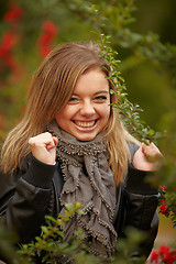 Image showing Beautiful positive girl in the bushes Viburnum