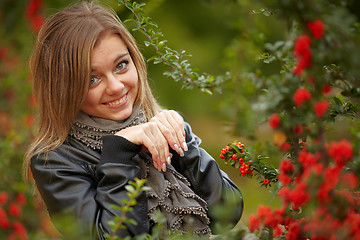 Image showing Beautiful girl near a positive snowball bushes.