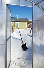 Image showing View of a country house inside the greenhouse winter day