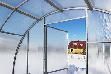 Image showing View of a country house inside greenhouse winter