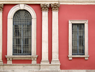 Image showing Red wall and ornate windows