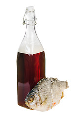 Image showing A bottle of domestic beer and dried fish is isolated on white 