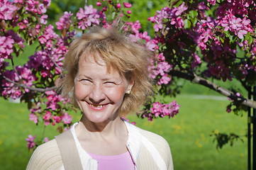 Image showing a middle-aged woman in a blossoming magnolias