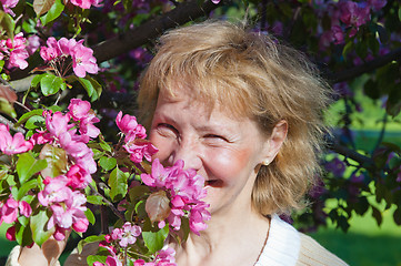 Image showing a middle-aged woman in a blossoming magnolias