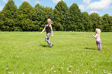 Image showing Mum with a daughter play to a glade