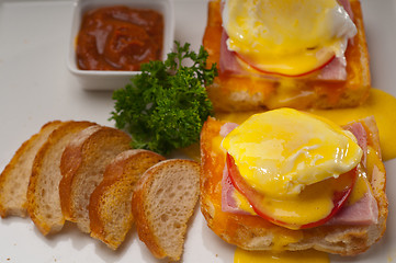 Image showing eggs benedict on bread with tomato and ham