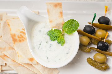 Image showing Greek Tzatziki yogurt dip and pita bread