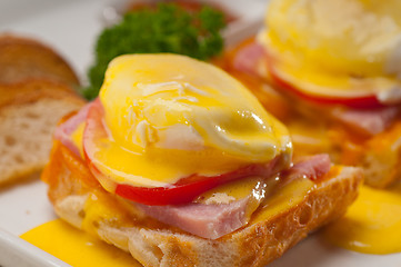 Image showing eggs benedict on bread with tomato and ham