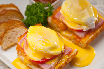 Image showing eggs benedict on bread with tomato and ham