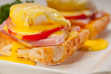 Image showing eggs benedict on bread with tomato and ham