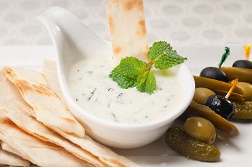 Image showing Greek Tzatziki yogurt dip and pita bread