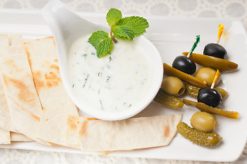 Image showing Greek Tzatziki yogurt dip and pita bread