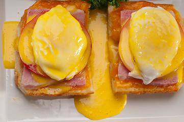 Image showing eggs benedict on bread with tomato and ham