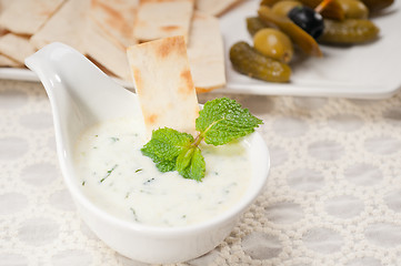 Image showing Greek Tzatziki yogurt dip and pita bread