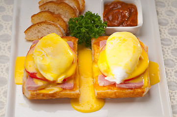 Image showing eggs benedict on bread with tomato and ham