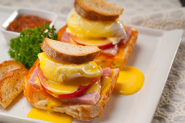 Image showing eggs benedict on bread with tomato and ham