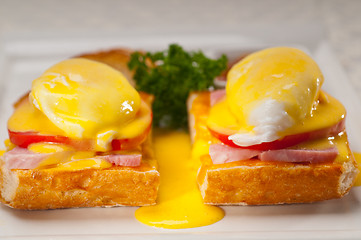 Image showing eggs benedict on bread with tomato and ham