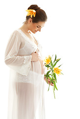 Image showing beautiful pregnant woman with yellow lily