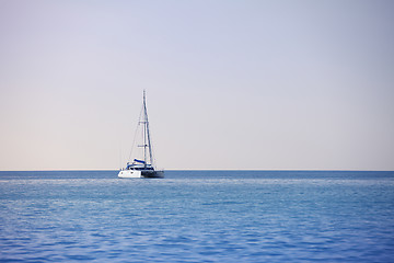 Image showing White sailing catamaran on calm sea