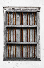 Image showing Old wooden window with rusty grate