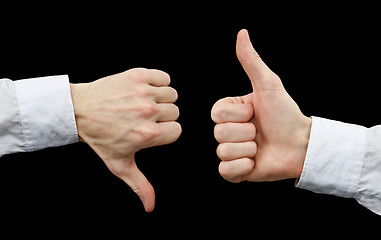 Image showing Two hands showing gestures thumb up & thumb down