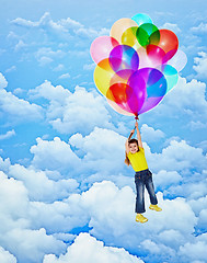 Image showing Cheerful girl flies with balloons