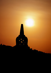 Image showing Decorative Buddhist stupa. Silhouette at sunset.