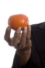 Image showing woman holding tangerine