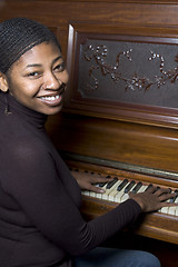 Image showing woman in front of old piano