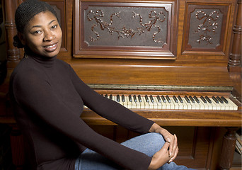 Image showing woman in front of old piano