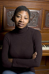 Image showing woman in front of old piano