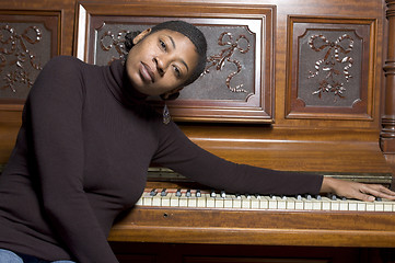 Image showing woman in front of old piano