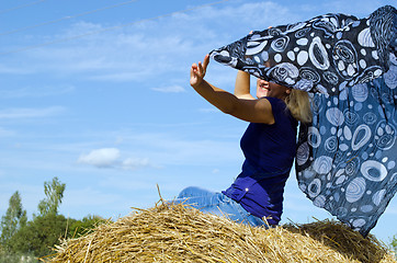 Image showing woman happy smile straw bale headscarf scarf wind 