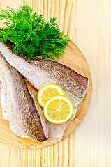 Image showing Fillet of codfish on a round plate with lemon