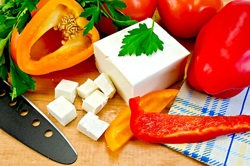 Image showing Feta cheese on the board with vegetables and herbs